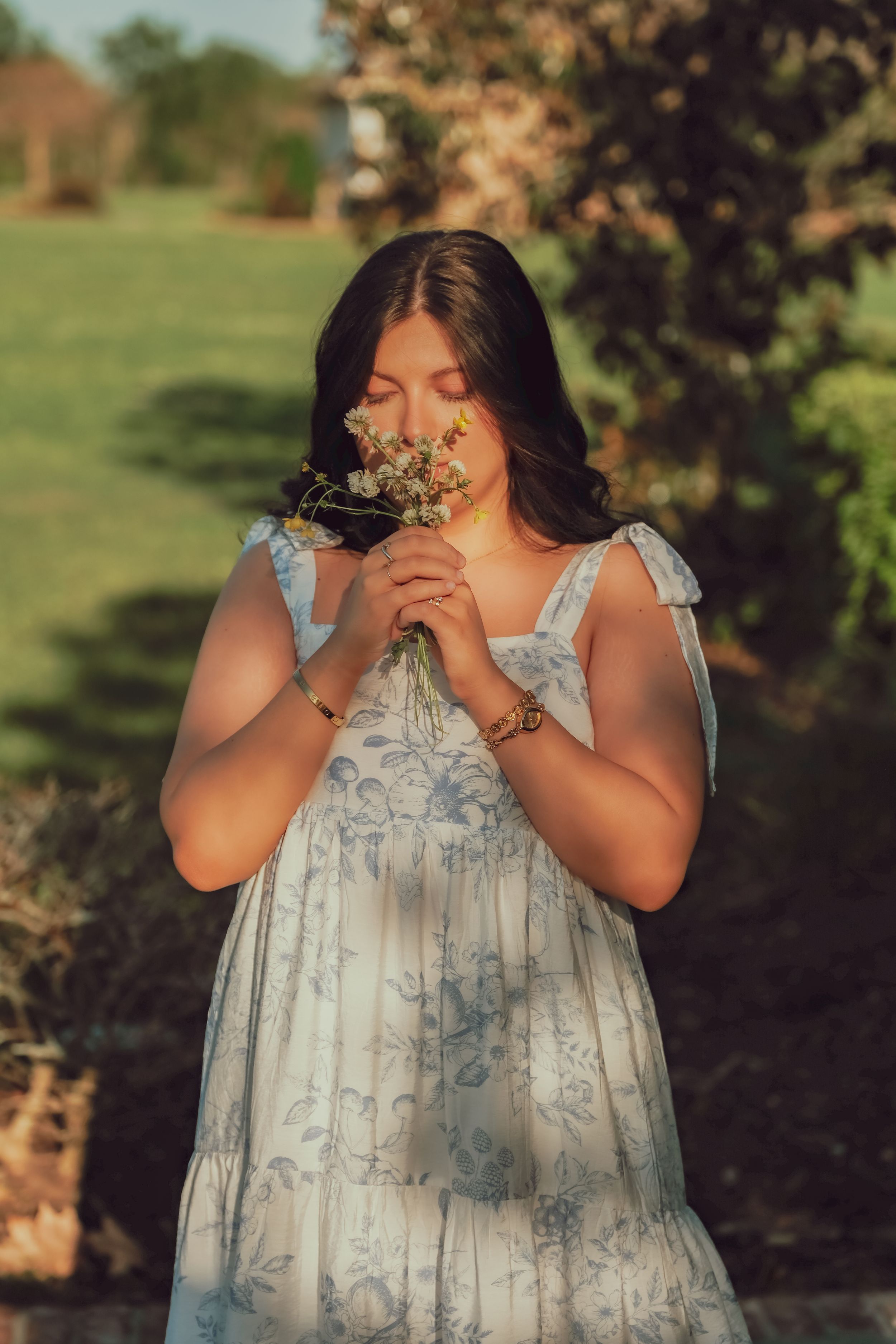 High school senior smelling a wildflower during her portrait session