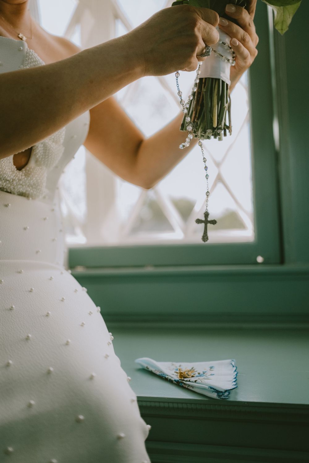Bride holding her bouquet and rosary while getting ready in Lafayette