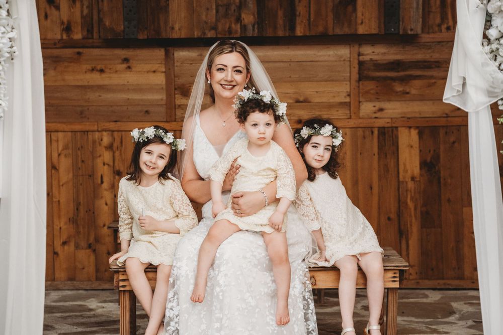 Bride seated with her daughters on her wedding day