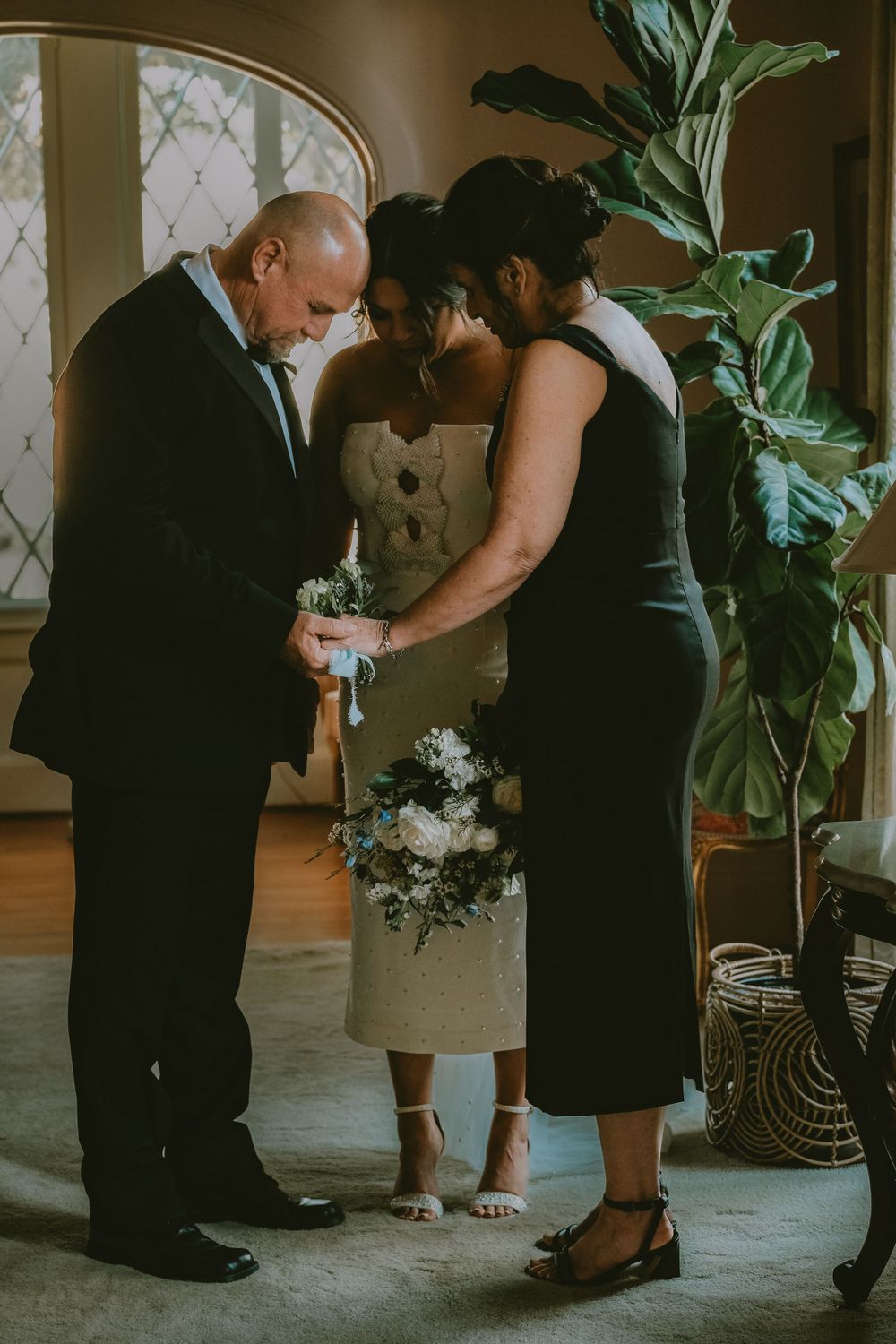 Family sharing a prayer before a Lafayette wedding ceremony