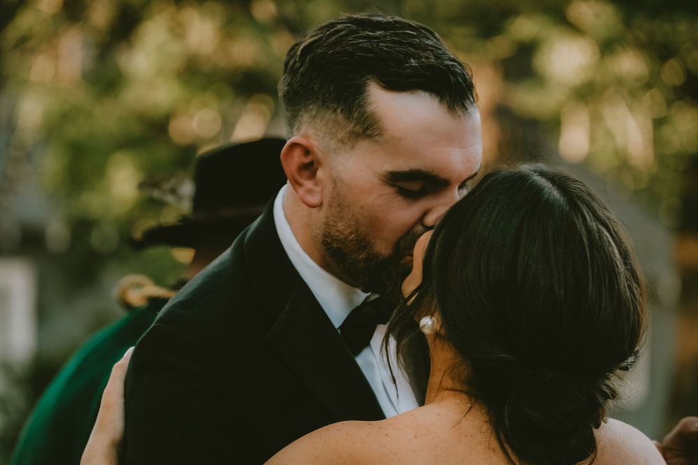 Bride and groom sharing their first kiss at an outdoor Lafayette wedding